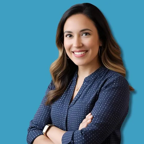 Headshot of Emily Carter, a writer for Quantify North America, smiling with arms crossed on blue background